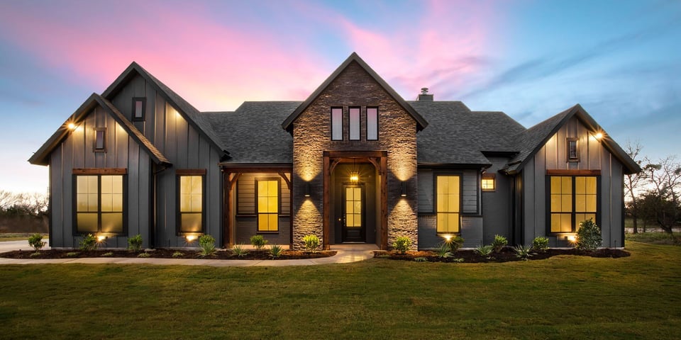 large luxury custom-built home with dark exterior in Austin texas