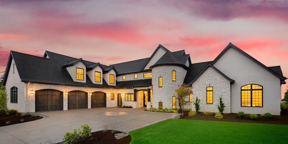 large custom home in austin texas with white exterior and dark roof