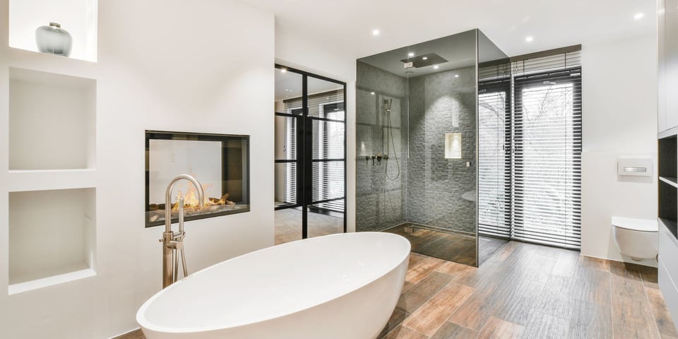 luxury bathroom remodel in austin texas with free standing tub and glass shower and fireplace